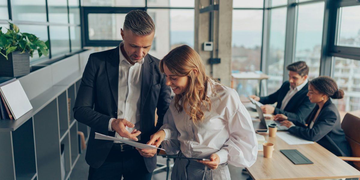 Two professional executives experts discussing financial accounting papers working together