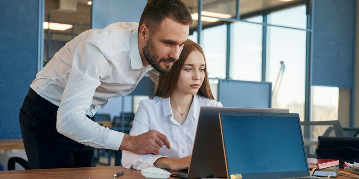 Working together. Man and woman employees are in the office